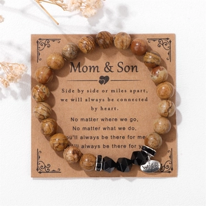 Close-up of Mom & Son 8mm stone bead bracelet with silver Wish tag on gift card packaging