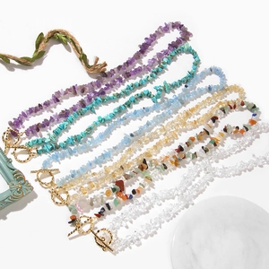 Detailed view of gravel gemstone necklaces with gold OT clasps and natural crystal textures