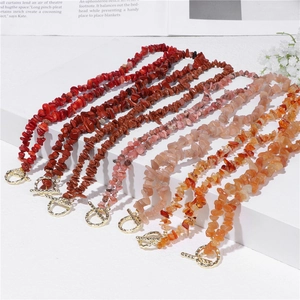 Macro detail of natural gravel stone necklaces with golden metal OT toggle clasps