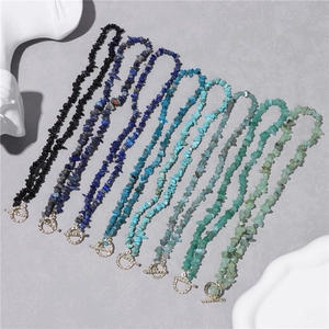 Close-up of eight multicolored natural crushed stone beaded necklaces with metal OT clasps