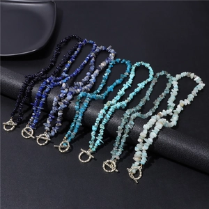 Detailed macro view of natural crushed stone beaded necklaces with vintage metal OT buckles