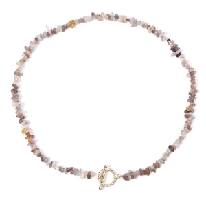 Detail of irregular natural stone beaded necklace featuring a golden metal OT toggle clasp