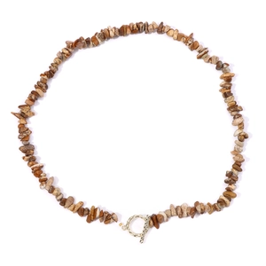 Detail of vintage bohemian stone bead necklace with textured gold OT toggle clasp