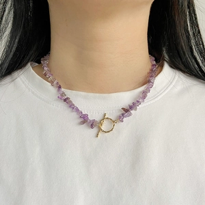 Natural amethyst gravel necklace with gold OT buckle on model wearing white shirt