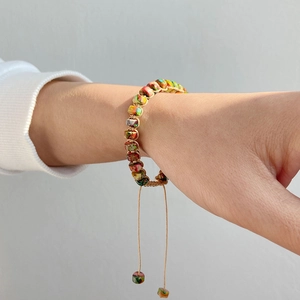 Detail van handgeweven armband met marmeren stenen kralen en een verstelbaar trekkoord