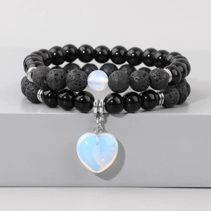 Detail of double-layer volcanic stone beads and heart pendant on a display stand