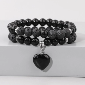 Close-up of double-layer volcanic stone beads and heart pendant with silver spacers