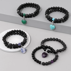 Detailed macro of double-layer volcanic stone bracelets with various heart gemstone charms