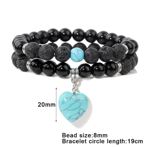 Detail showing 8mm volcanic stone beads and 20mm blue heart pendant on a double bracelet
