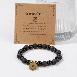 Pulsera del zodiaco Géminis con cuentas de piedra de lava negra y dije dorado