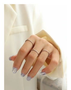 Close-up of minimalist silver stacking rings worn on fingers for a sleek and modern look