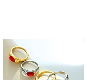 Detailed macro view of vintage seal rings with red oval stones and carved side patterns