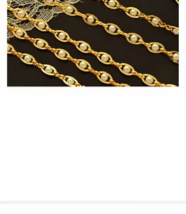 Macro detail of gold-plated tiger zodiac necklace chain with white pearls and lace