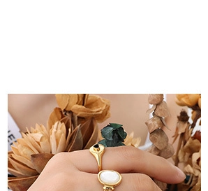 Close-up of vintage 18K gold plated rings with heart and oval mother-of-pearl inlays
