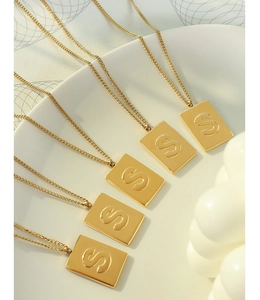 Detailed view of 18K gold plated stainless steel square pendant necklaces with letter S