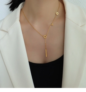 Detail of 18k gold plated stainless steel Love letter necklace on model neck