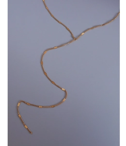 Detail view of gold titanium body chain with rectangular stamped textured metal plates