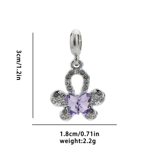 Macro detail of silver butterfly charm with purple crystal and zirconia pave setting