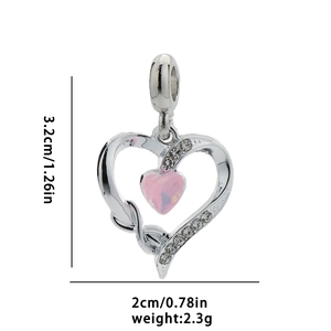 Macro view of silver heart pendant with pink gem and clear size labels 3.2cm by 2cm