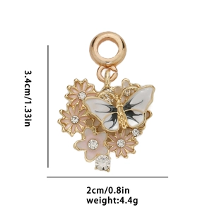 Detail of butterfly and flower pendant with enamel coating and white crystals
