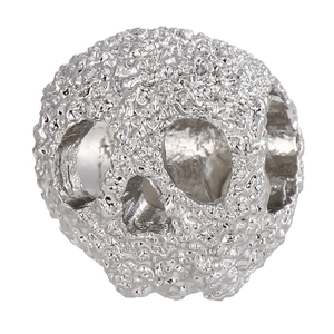 Détail macro d'une perle crâne en métal argenté avec texture martelée pour bijoux DIY