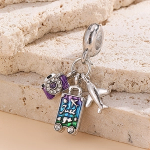 Travel charms pendant featuring purple camera, turquoise suitcase and silver airplane