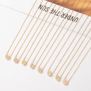 Gold chain necklace set featuring circular initial pendants with micro-inlaid cubic zirconia