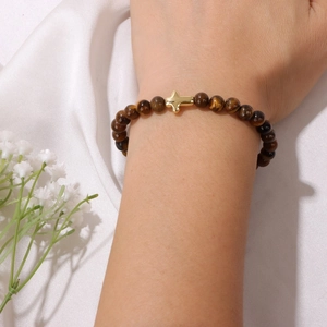 6mm Tiger Eye stone beaded bracelet with golden cross charm on female wrist