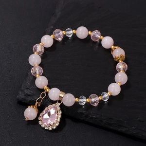 Detail of beaded bracelet with pink crystal teardrop pendant and sparkling stones