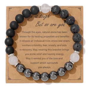 Handmade natural stone beaded bracelet with lava and hematite on kraft display card