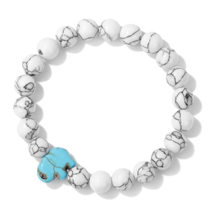 Macro detail of turquoise elephant bead and white marble stone stretch bracelet