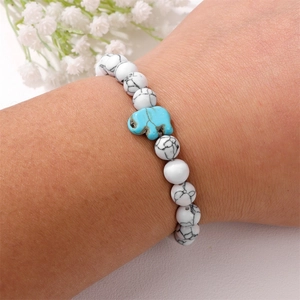 Howlite beaded elephant bracelet with blue turquoise charm on a female wrist