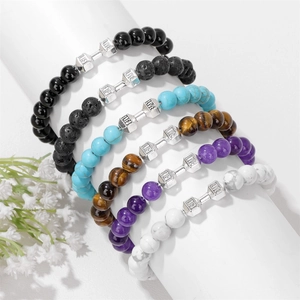 Dumbbell beaded bracelets set with tiger eye and volcanic stone on display stand