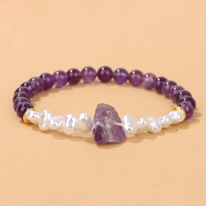Detail of 6mm purple amethyst and baroque pearl bracelet with gold spacers and raw stone