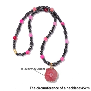 Agate pendant necklace with black hematite beads and pink irregular stone center piece