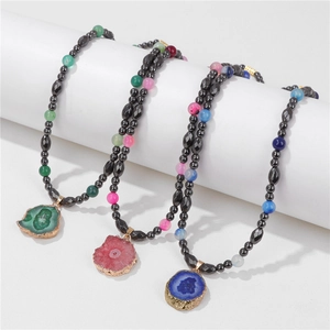 Detailed close-up of natural druzy agate pendants with black hematite bead necklaces