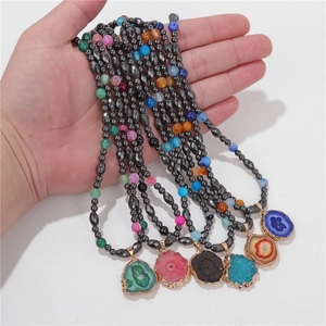 Detail of colorful agate stone pendants with magnetic hematite bead necklaces