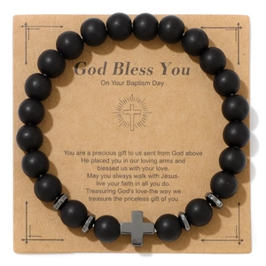 Matte black stone bead bracelet with silver cross pendant on religious gift card