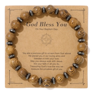 Detail of beaded religious bracelet with tiger wood beads and cross gift card packaging