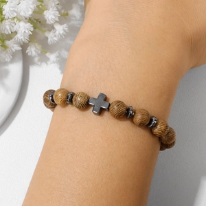 Natural wood bead bracelet with stone accents and a polished grey metal cross pendant
