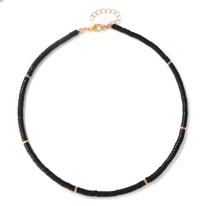 Detail of black Heishi bead necklace with gold spacers and lobster clasp closure