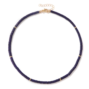 Macro view of blue lapis lazuli cylinder bead necklace with gold spacer discs and clasp