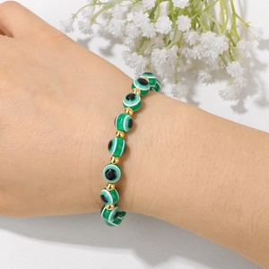 Bohemian Evil Eye beaded bracelet with green resin beads and 18k gold metal spacers