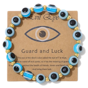 Blue and white Evil Eye beaded bracelet with gold spacers on kraft card packaging