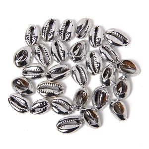 Detailed macro view of silver plated cowrie shell charms for DIY jewelry making sets