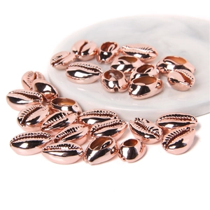 Macro shot of rose gold shell beads for DIY jewelry with polished mirror finish