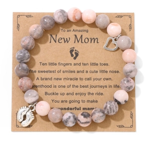 Pink marble bead bracelet with heart and baby feet charms on New Mom gift card