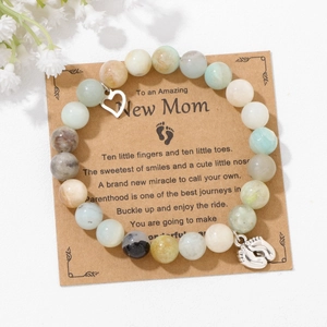Close-up of blue imperial stone beaded bracelet with heart and baby feet charms
