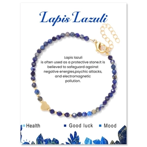 Detail view of Lapis Lazuli beaded bracelet with gold heart charm on display card