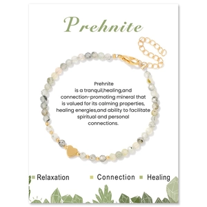 Detailed macro view of 3mm faceted prehnite beaded bracelet with a gold heart charm